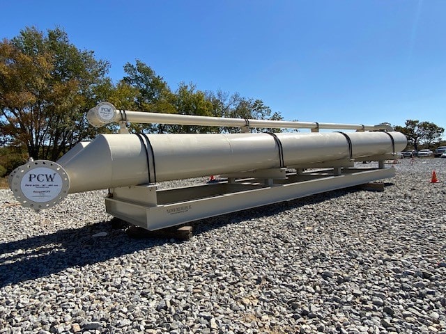 PCW industrial separator unit positioned on a gravel yard with trees in the background